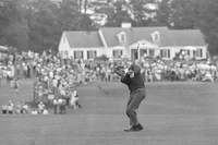 Black and white photo from 1969 of golfer Arnold Palmer hitting a golf ball at a major competition.