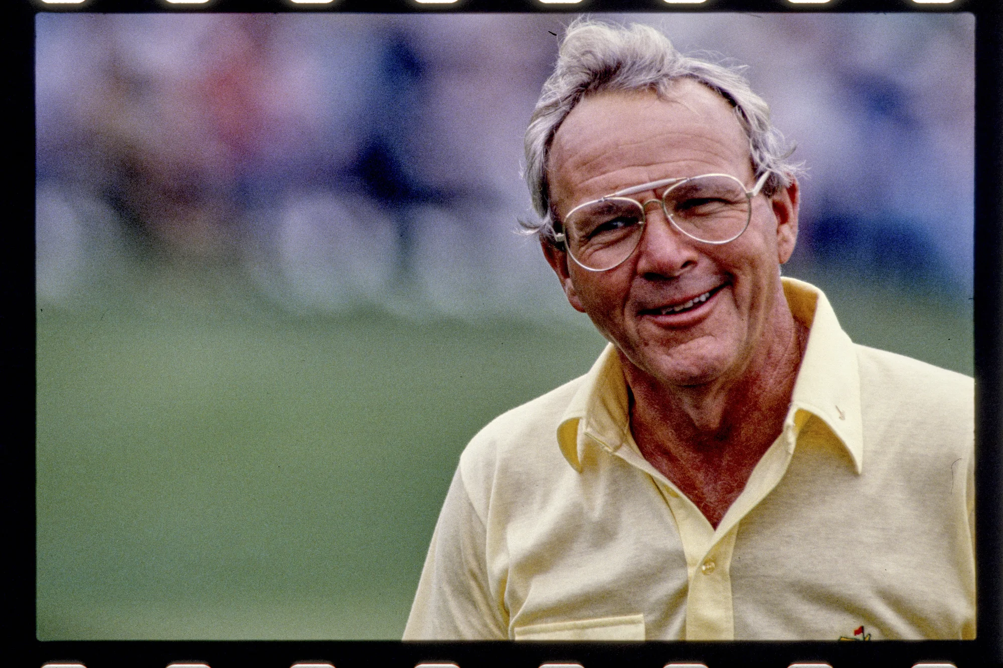 Close up photo of Arnold Palmer smiling at a major competition.