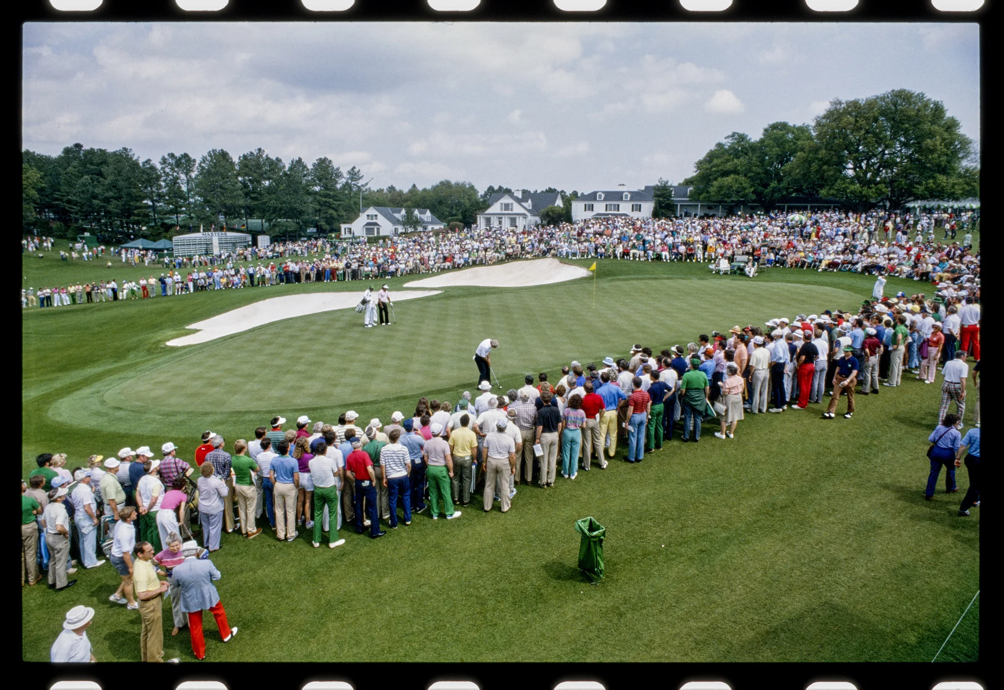 A crowd gathering to watch golf.