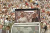 Pope John Paul II and a cardinal in the Pope Mobile inside the Silverdome in Detroit, Michigan.