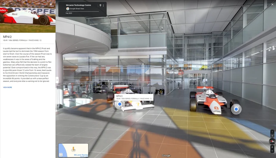 Street View imagery shows inside the McLaren Technology Center shows multiple McLaren race cars and a side panel featuring additional information about one of the cars.