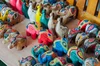 rows of colorful intricately decorated wooden elephant carvings