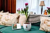 Google Tulip, alongside a Google Home Hub on a couch