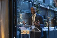 a man stands at a podium speaking