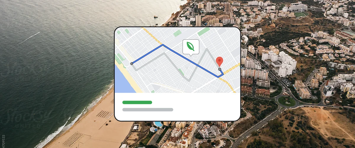 Aerial shot of an oceanside town with a graphic overlaid on top showing an illustration of Google Maps with a green leaf indicating an eco-friendly route.