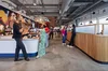 Googlers chat in the WERD Cafe in the Atlanta Google office, featuring a large mural on the wall.