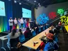 Students pictured listening to Google engineers speaking on a stage at the Google Venice Office.