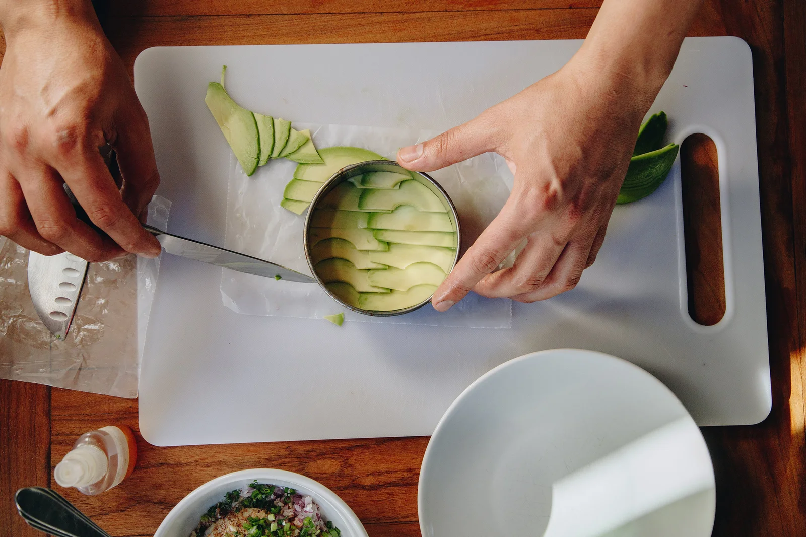 An overhead view of a  chef at Julia Restaurante preparing an avocado dish.