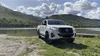 A pickup truck with a Street View camera on top parks in front of a lake