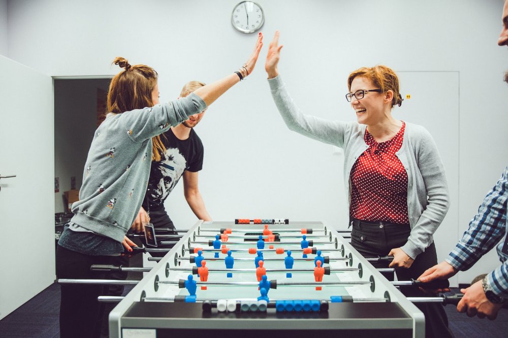 People playing foosball.