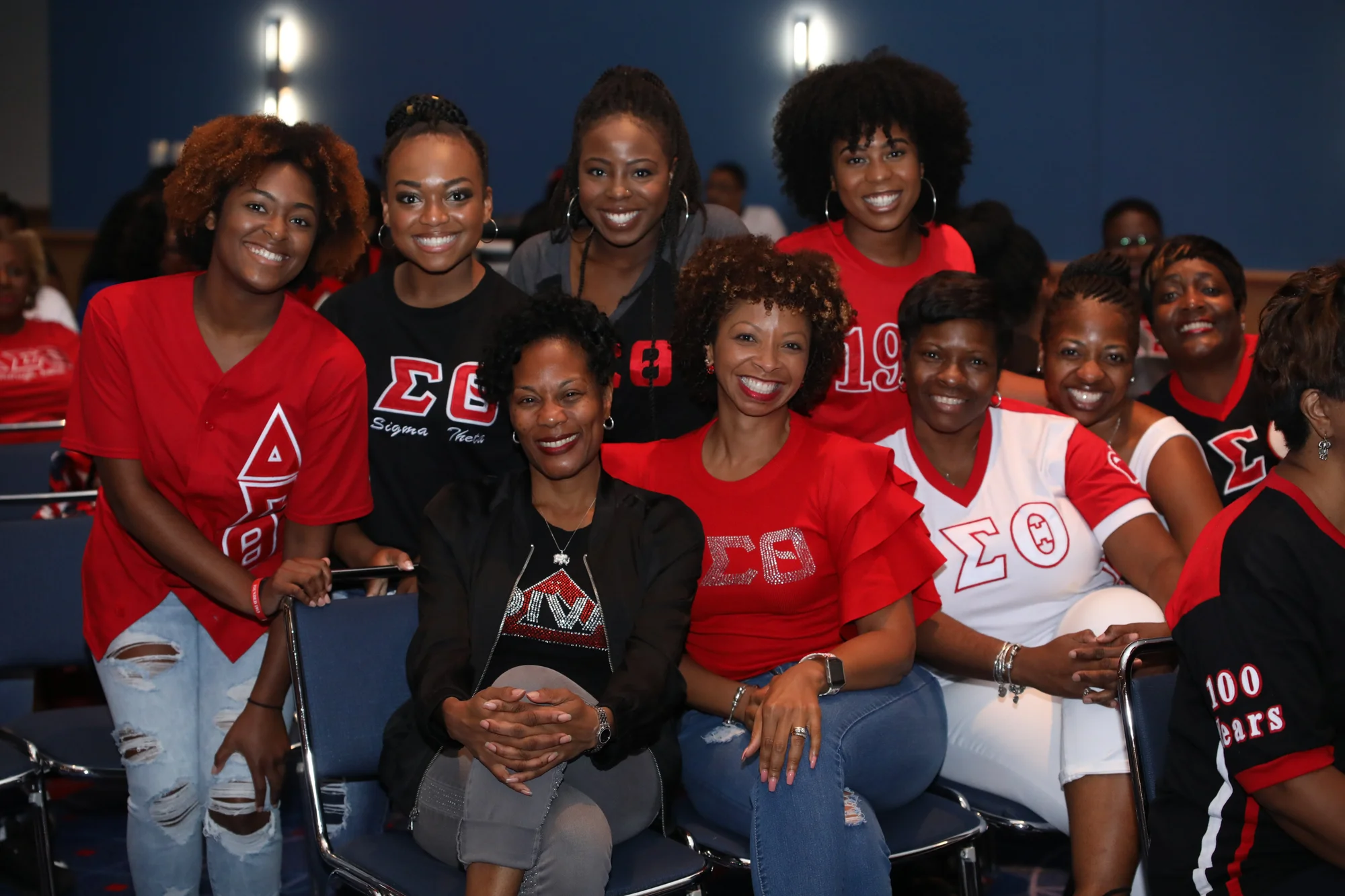 A group of women wearing red and black Delta Sigma Theta sorority apparel