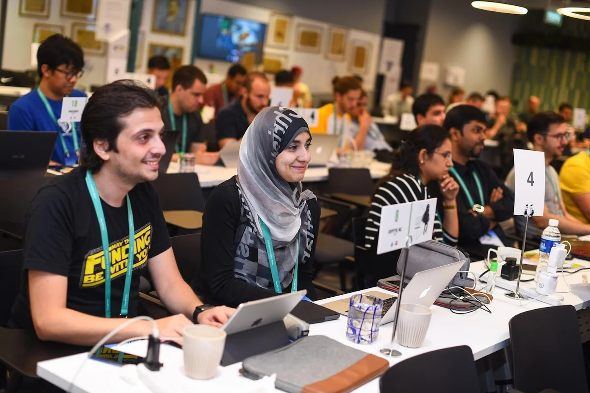 Picture of attendees with their laptops and notes.