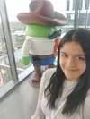 Nathalia poses in front of a large Android statue (which is dressed up as a cowboy).