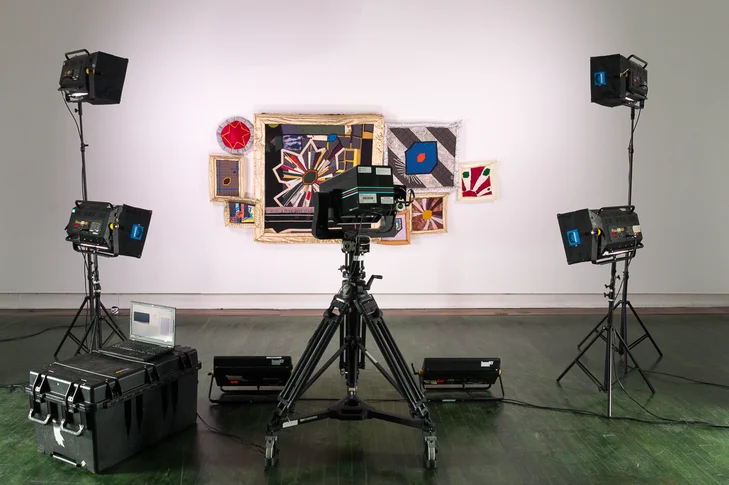 Photo of a room with multiple lights and the Art Camera aiming at a frame on the wall of the Museo de Arte Contemporáneo de Puerto Rico