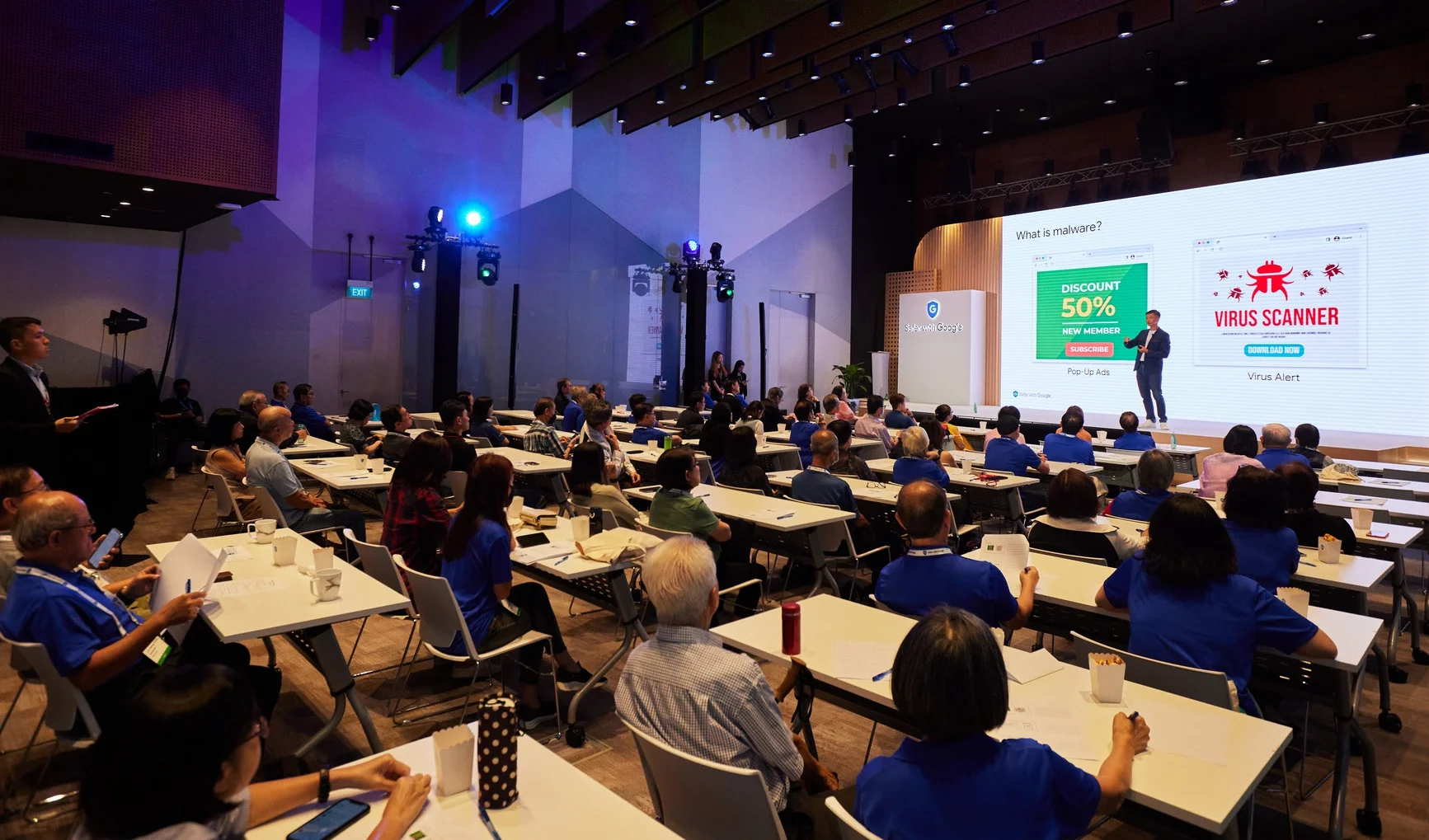 image of Google’s Norman Ng speaking at event in Singapore attended by a ground of senior citizens