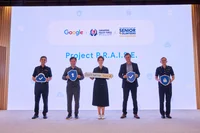 Five people standing on a stage in front of a screen that reads "Project PRAISE"