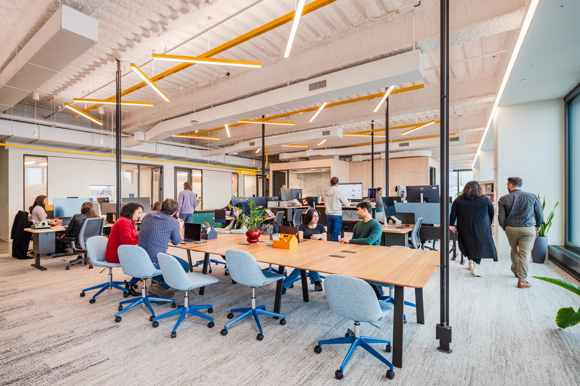 Googlers work together at a communal table in one of St. John's Terminal's, shared neighborhoods.