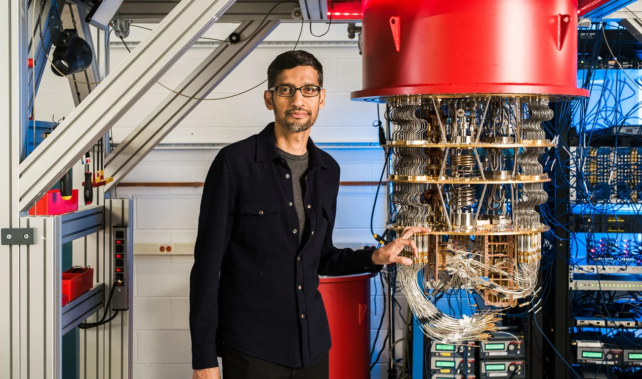 Google and Alphabet CEO Sundar Pichai stands near quantum computing equipment.