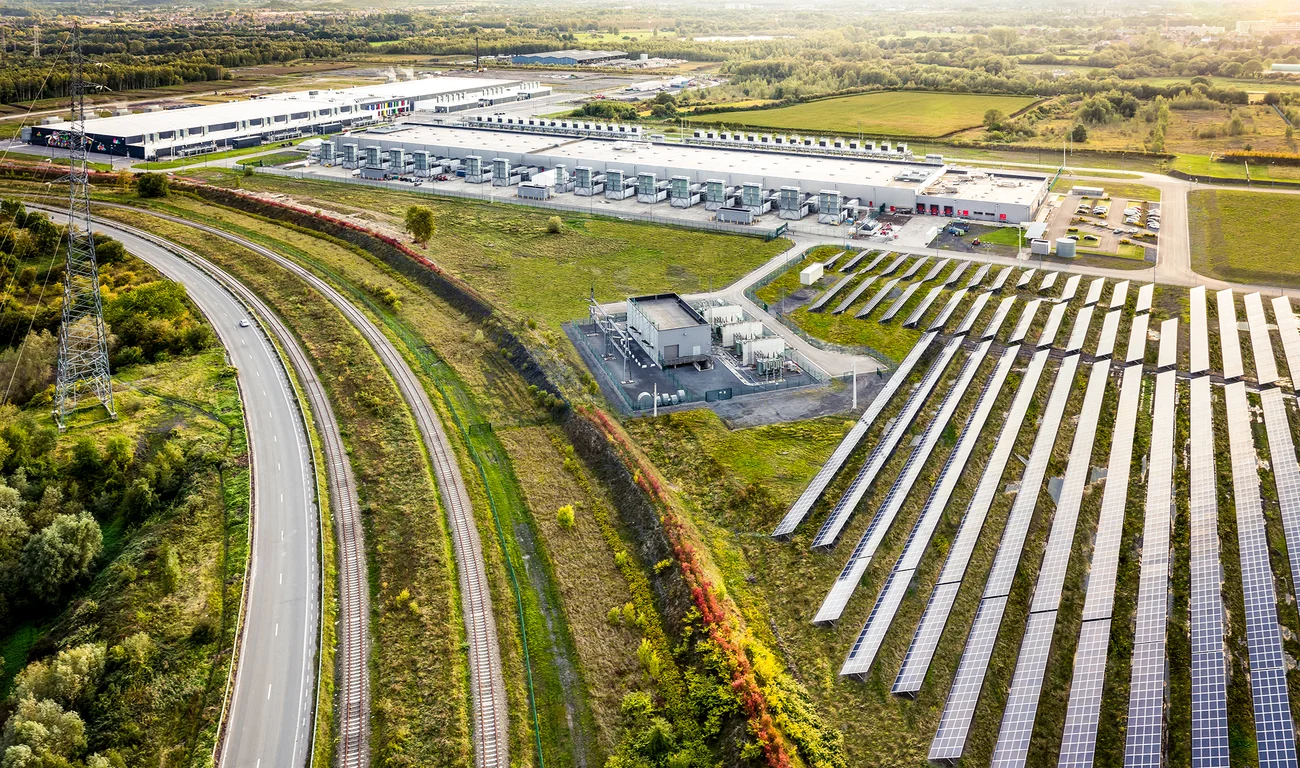 An aerial photograph of solar panels as part of an electrical power plant.