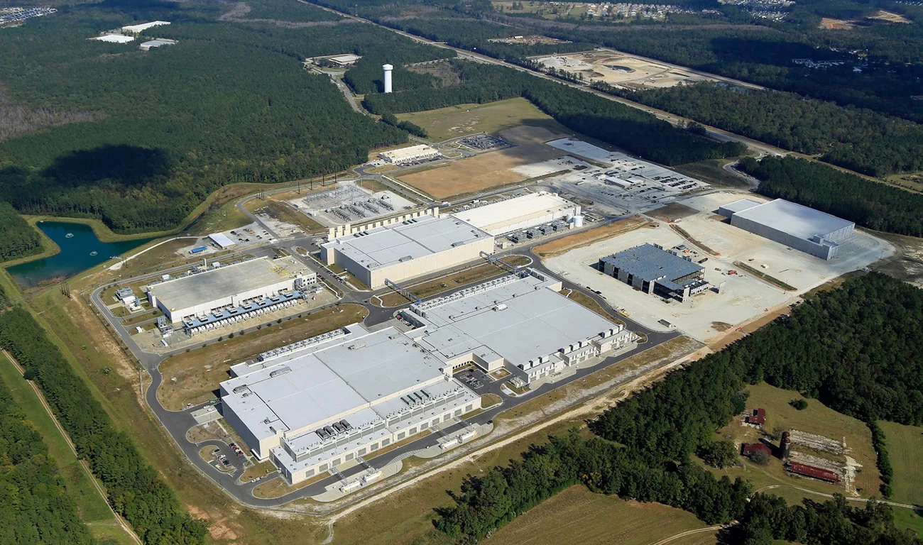 A photo taken from the air of a Google data center, showing multiple large buildings.