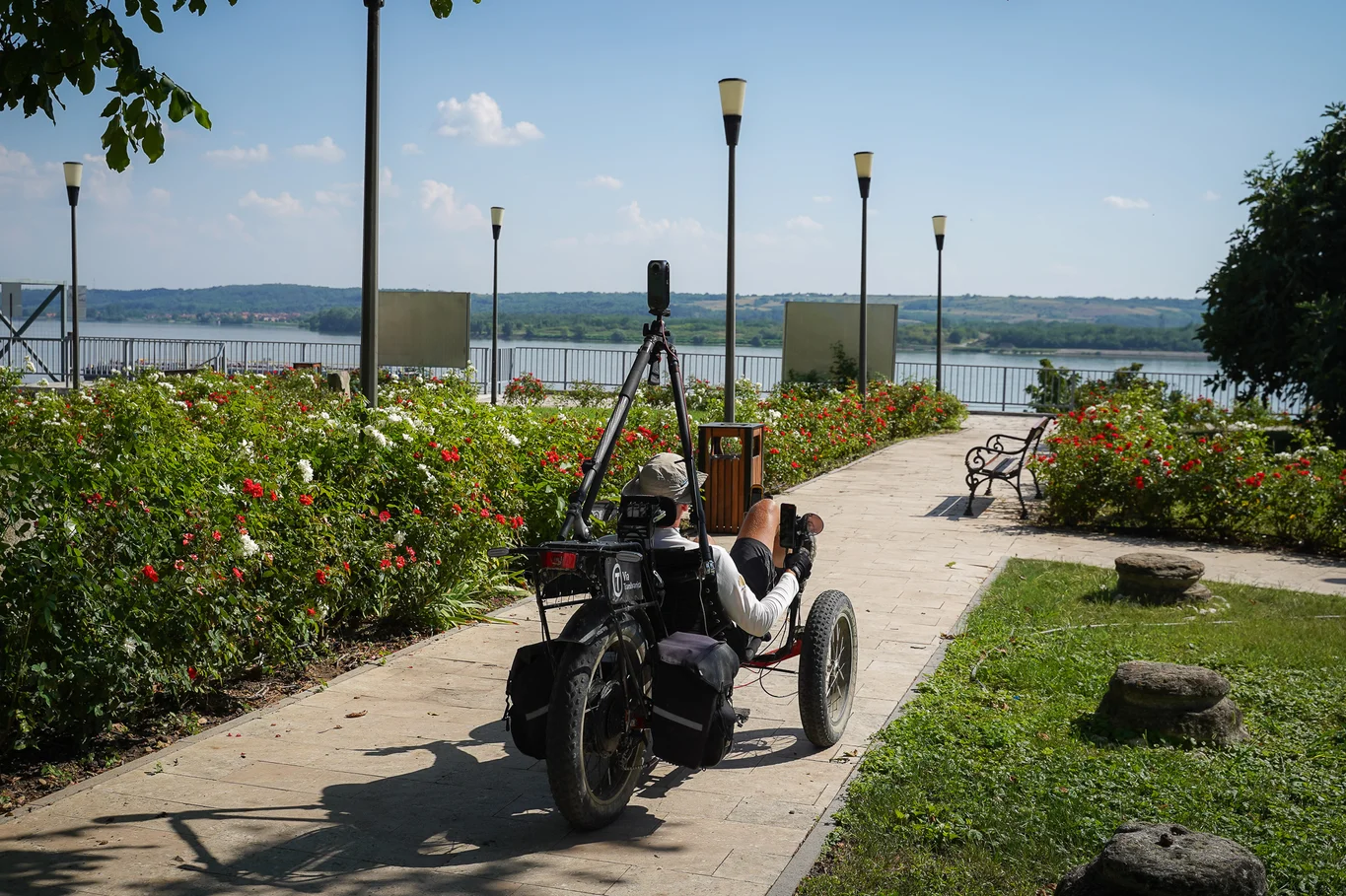The trike surrounded by blooming flower, overlooking the Danube river.