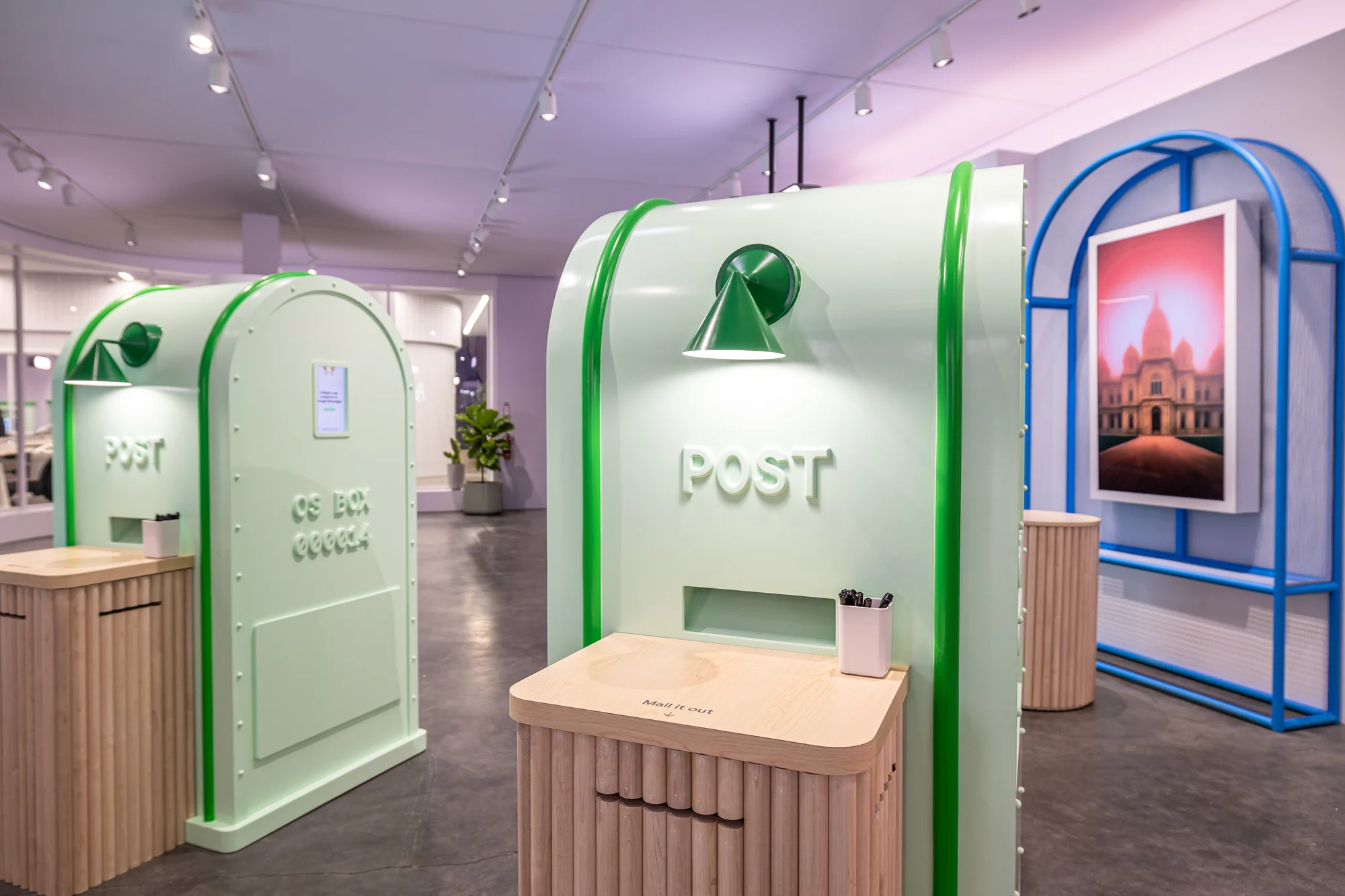 The third shows the demo room for Magic Compose where two large post boxes wait for people to try creating custom postcards.