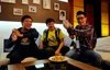 An image of three male youths sitting on a couch, laughing and interacting with one another. They are YouTube creator Gogogoy, and two developers from the company, Own Games ID.