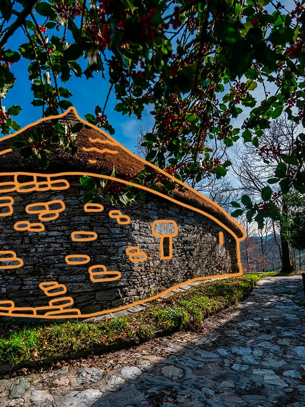 Image of a traditional Galician construction, a low, round building with a thatched roof. Orange bricks have been drawn on top of the image.