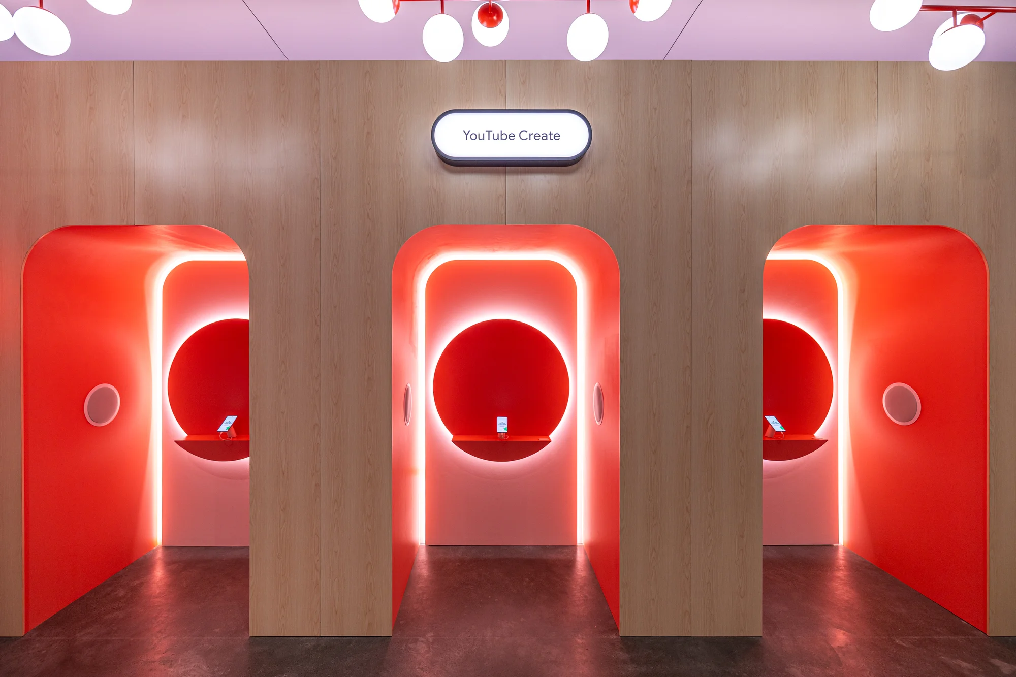 The fourth shows the YouTube Create Space, a bright red room with three alcoves where people can test out their creative skills.