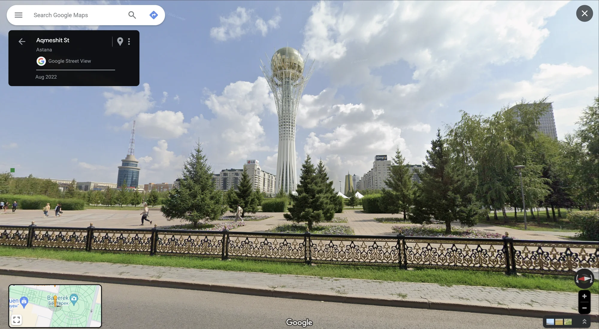 The Baiterek monument and observation tower, set against a blue sky with white clouds