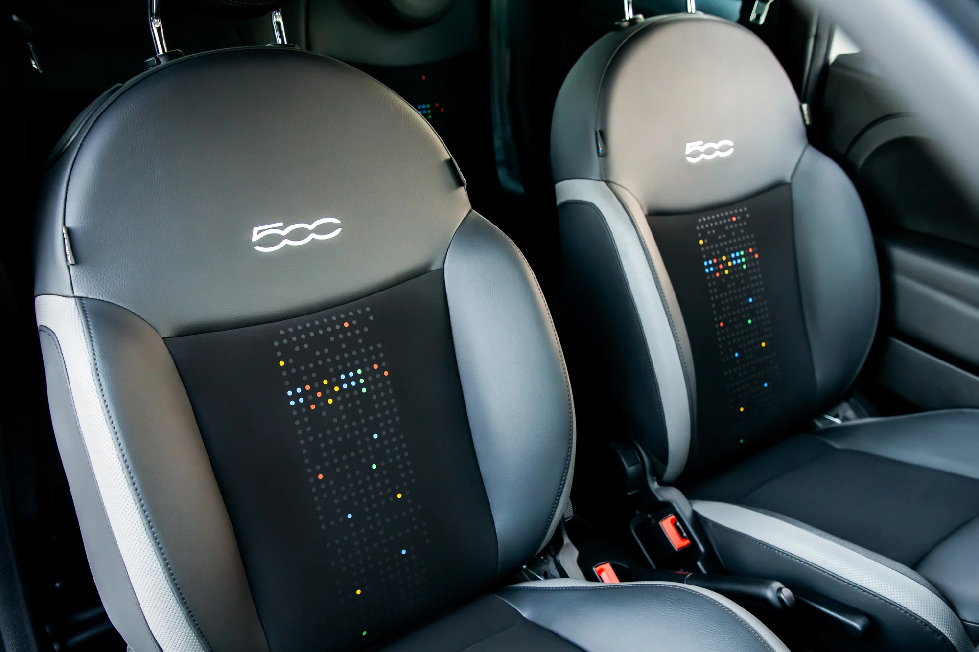 A close-up of the Fiat 500's interior seats, showing Google coloring.