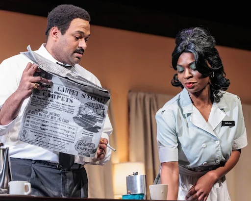 a picture of two people, a man holding a newspaper and a woman looking toward the floor