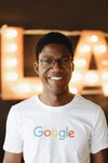 Goodman posing indoors wearing Google shirt.