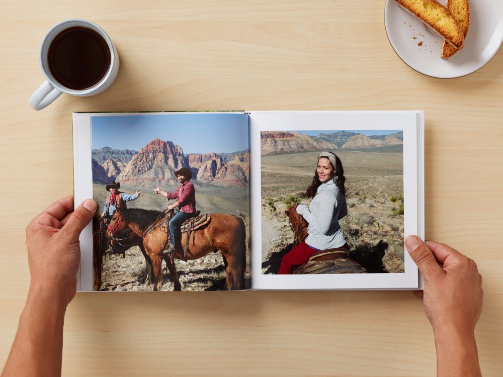 Image of people looking at a photo book from Google Photos.