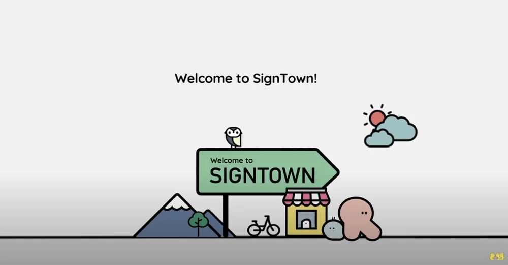 A video explaining what Sign Town can help people do, and how it works. In the video, a cartoon figure leaves its house, catches a bus, orders in a restaurant, checks into a hotel and requests shampoo and soap.