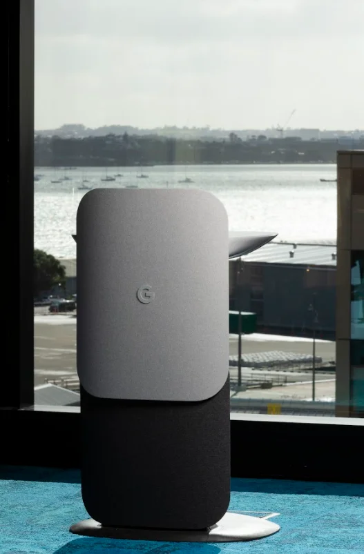 A photo of Google hardware in front of a window overlooking Auckland's harbour