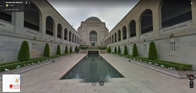 Street View imagery of the Australian War Museum, showing the pool of reflection in the Commemorative Courtyard and surrounding arched buildings