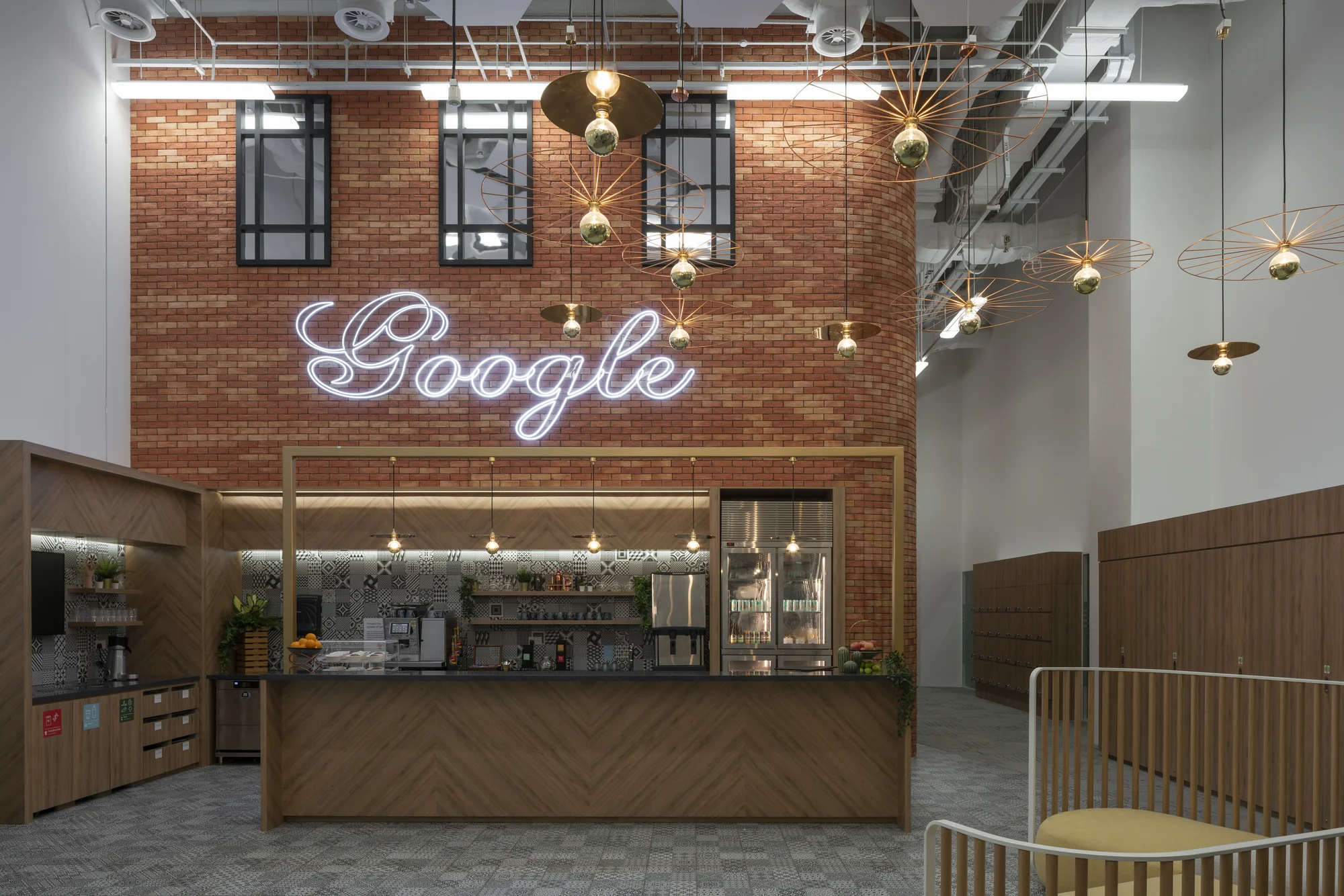 An indoor kitchen with a brick wall and a neon sign reading "Google".