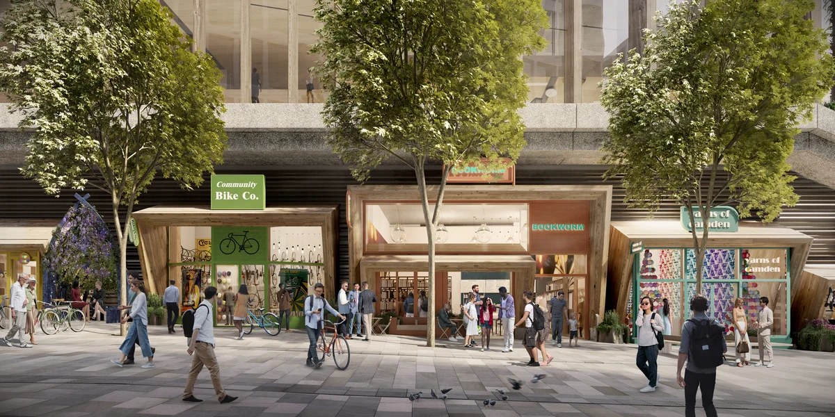 A computer generated image showing the ground floor of Google’s new building on King’s Boulevard. Three shops are pictured; a bike shop, a book shop and a textile store. Several people are pictured in the foreground.