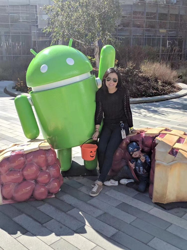 Belle and her son posing on Halloween in front of an Android pie statue.