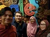 four people take a selfie in front of a Google sign