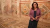 Bettany Hughes  standing inside one of the rooms at the Zeugma Mosaics Museum