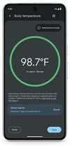 A Pixel 8 Pro showing the body temperature feature within the Thermometer app on its screen. A green circle is in the center, showing large numbers that read “98.7 degrees Fahrenheit.” Underneath these in smaller text, it reads “3+ years - Normal.” There is more support text underneath this and two oval icons in the corners of the screen, the one on the left reads “reset” and on the right says “save.”