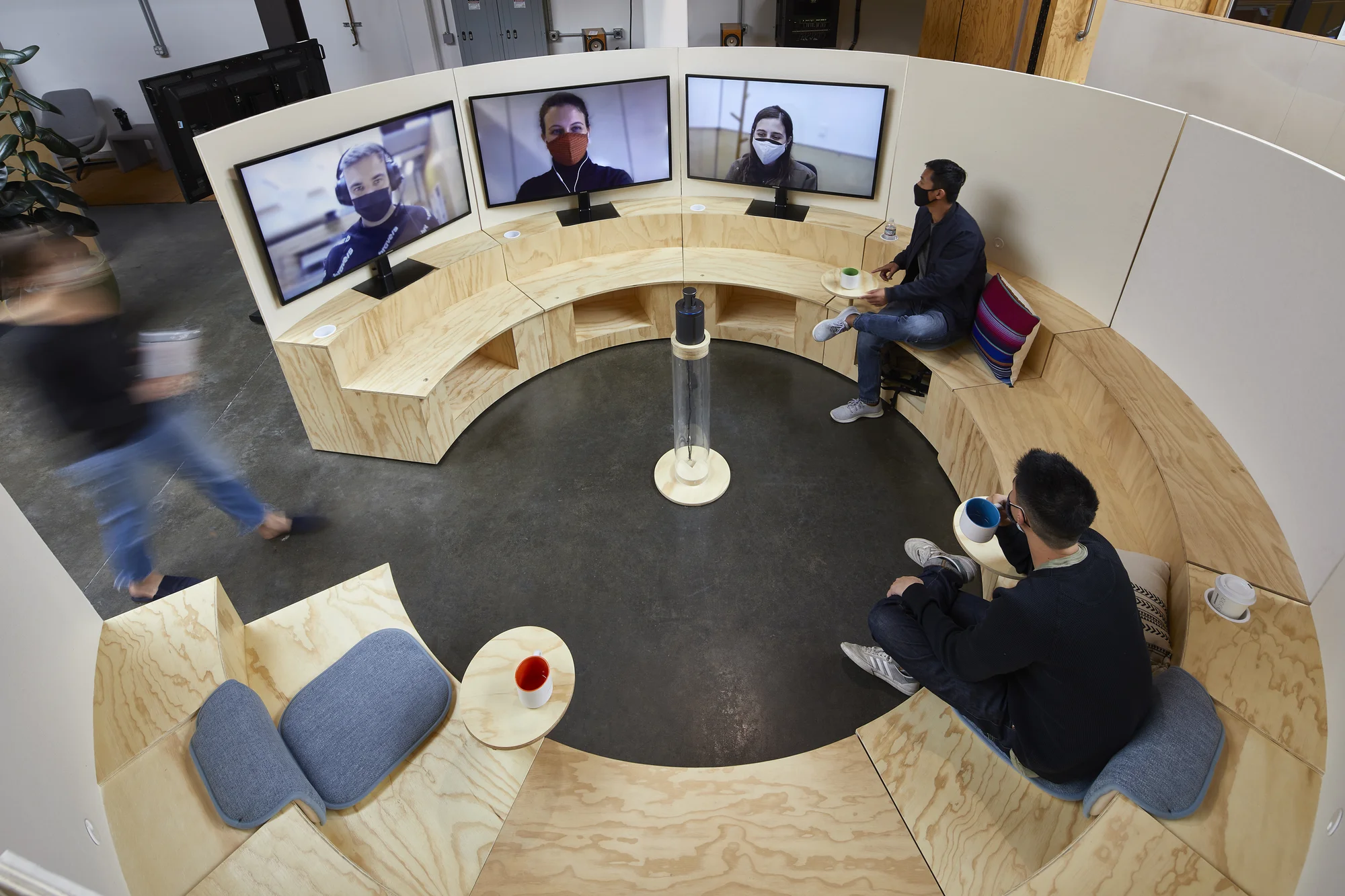 A "Campfire" space: A circular seating area with 2 people sitting in person, and 3 more on individual videoconference screens.