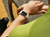 A cyclist looking down at a Fitbit Charge 6 on his wrist