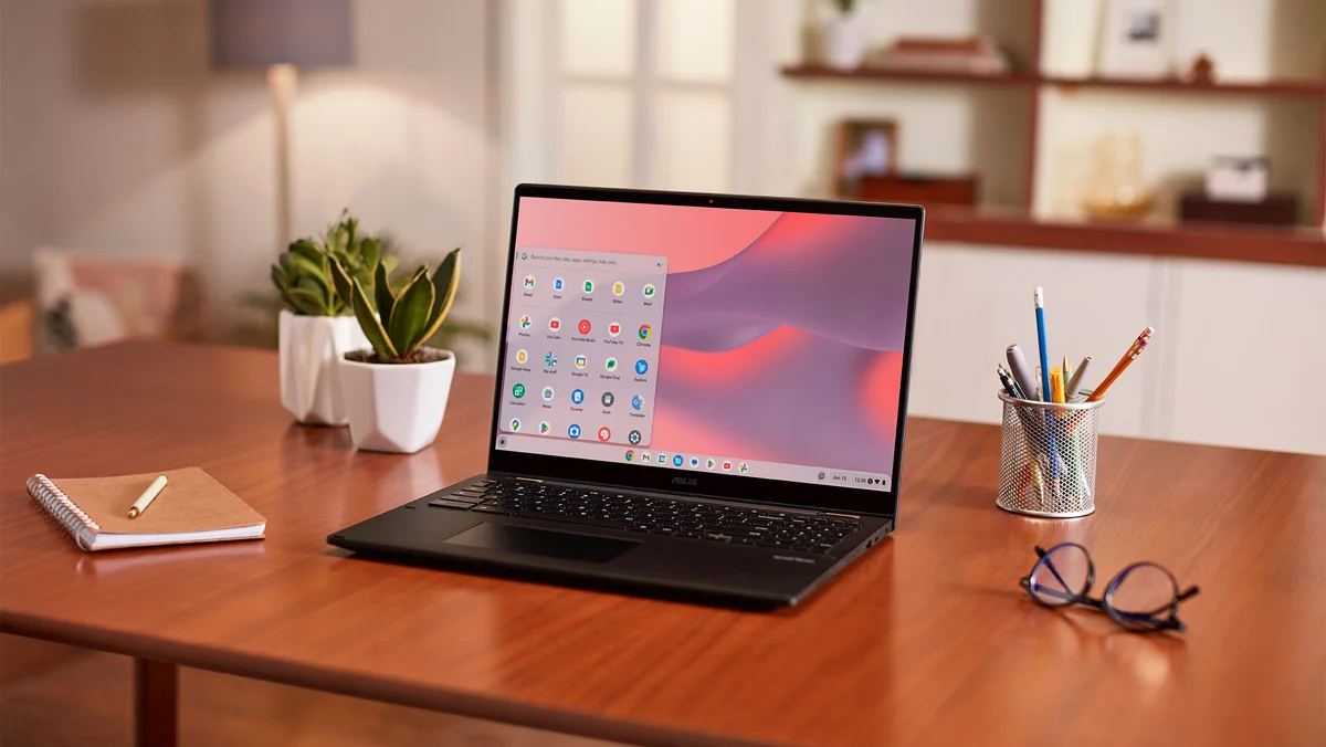 A Chromebook open on a desk in a home office