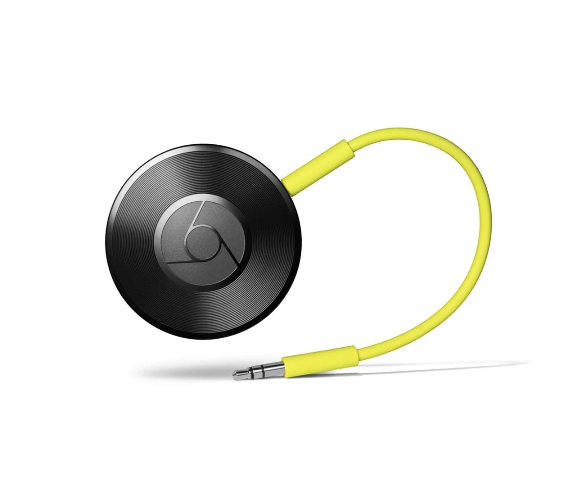 A small, black, puck-shaped device with textured concentric rings around a Chrome logo with a yellow cable attached