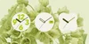 Light green photo of flowers as Android wallpaper. The analog clock selection in the foreground shows three different types of analog clock faces.