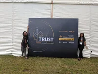 Courtney is on the left of a giant billboard at the CGIAR Platform for Big Data in Agriculture summit in 2019 and Diana is on the right side of the same sign.