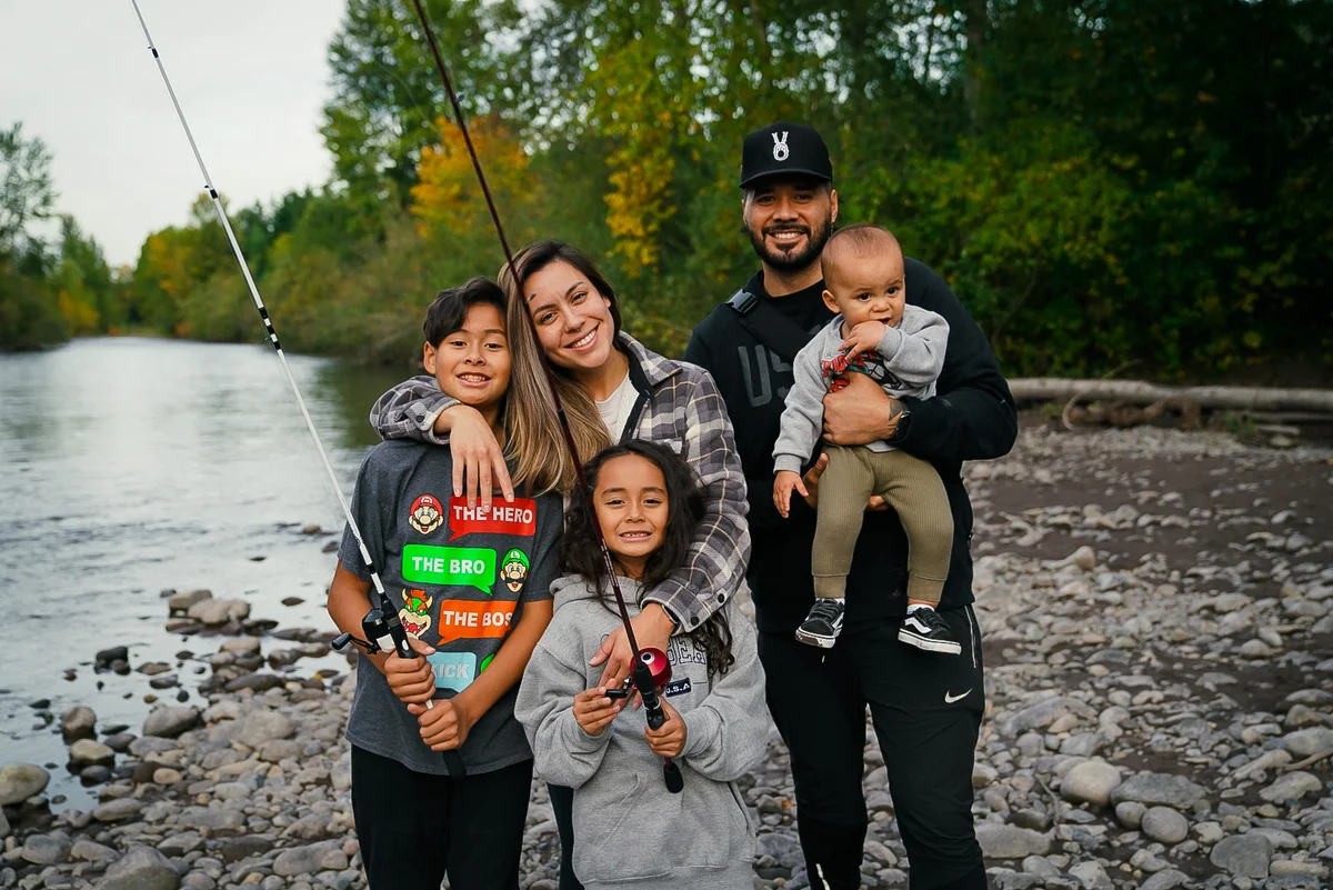 A mother, father and three kids on a fishing trip